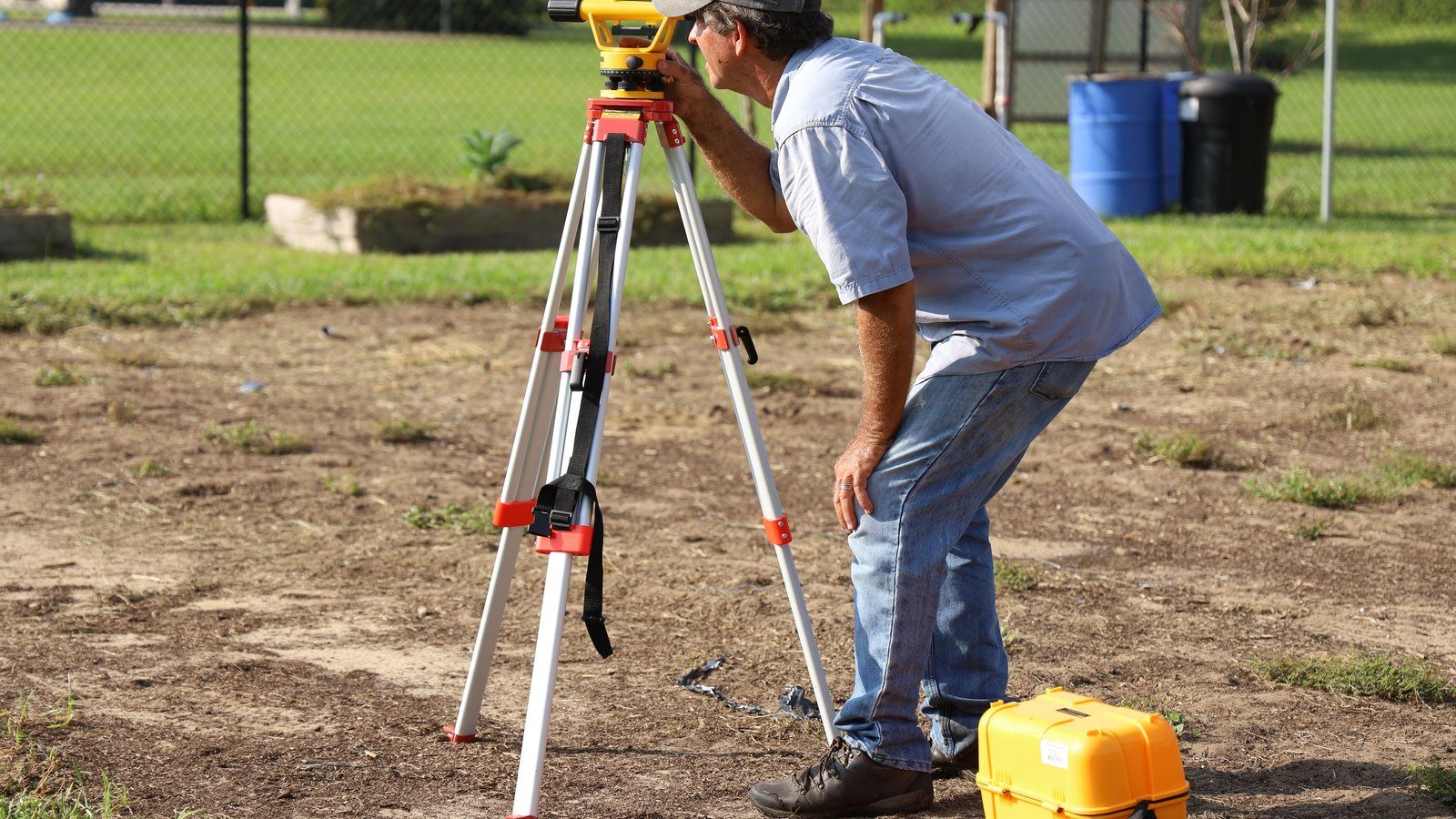 Licensed surveyor measuring land for a Maryland homebuyer property survey