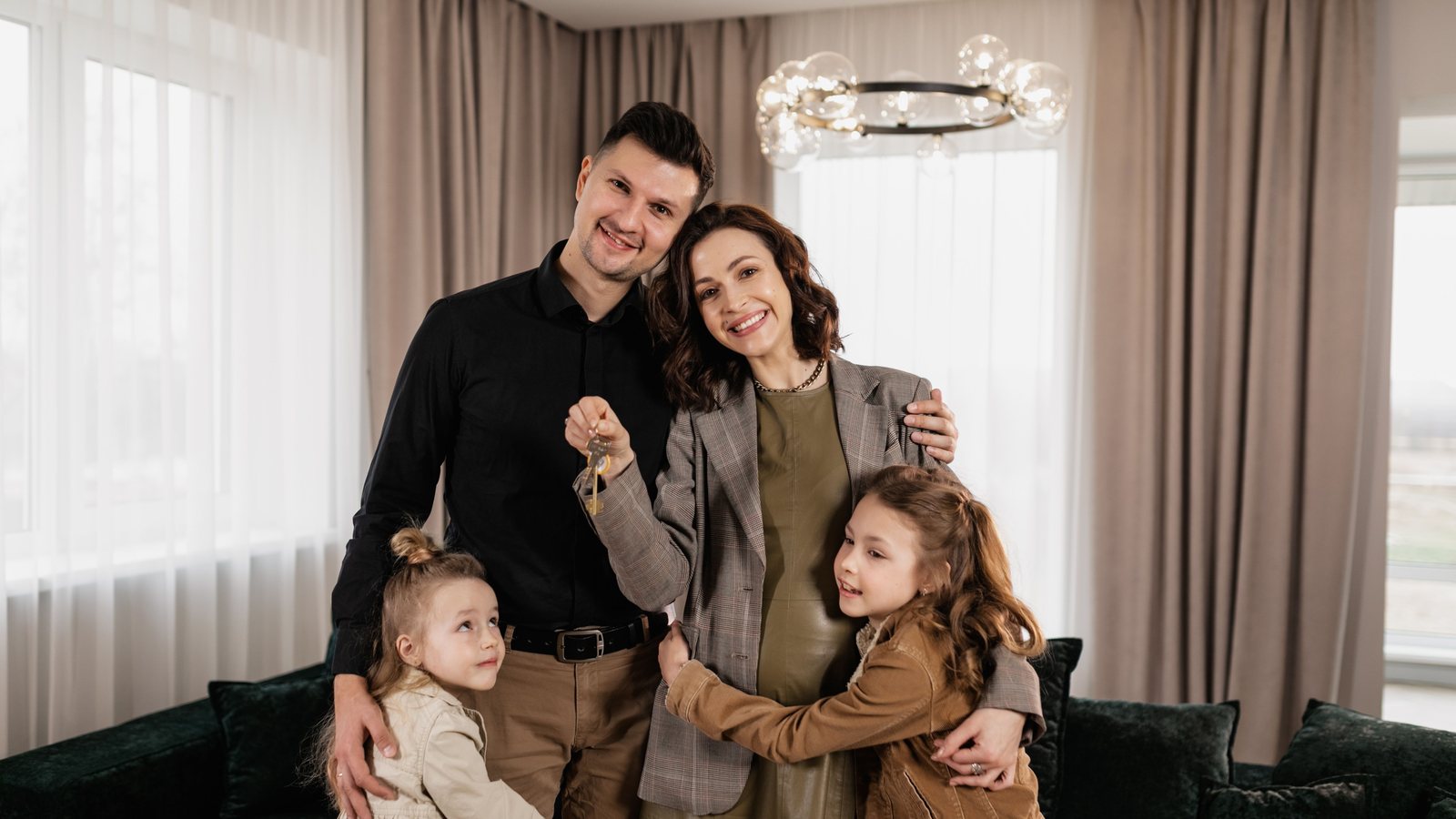 Family holding home keys representing a VA mortgage assumption for Southern Maryland buyers and sellers